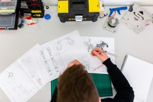 Engineer working on technical drawings