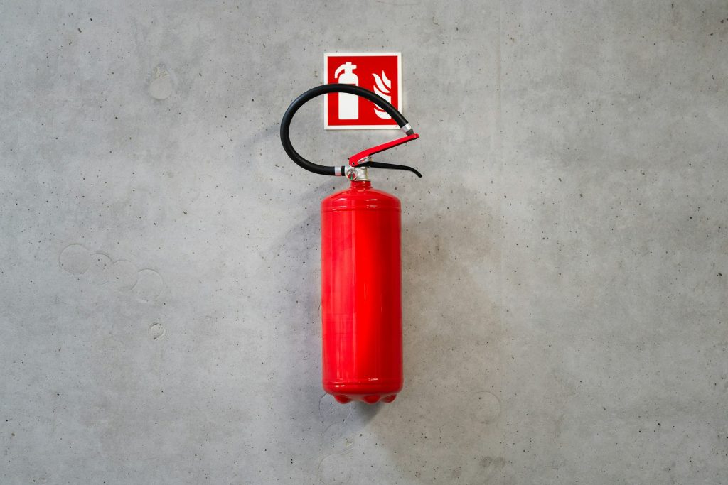 Fire extinguisher on a concrete wall