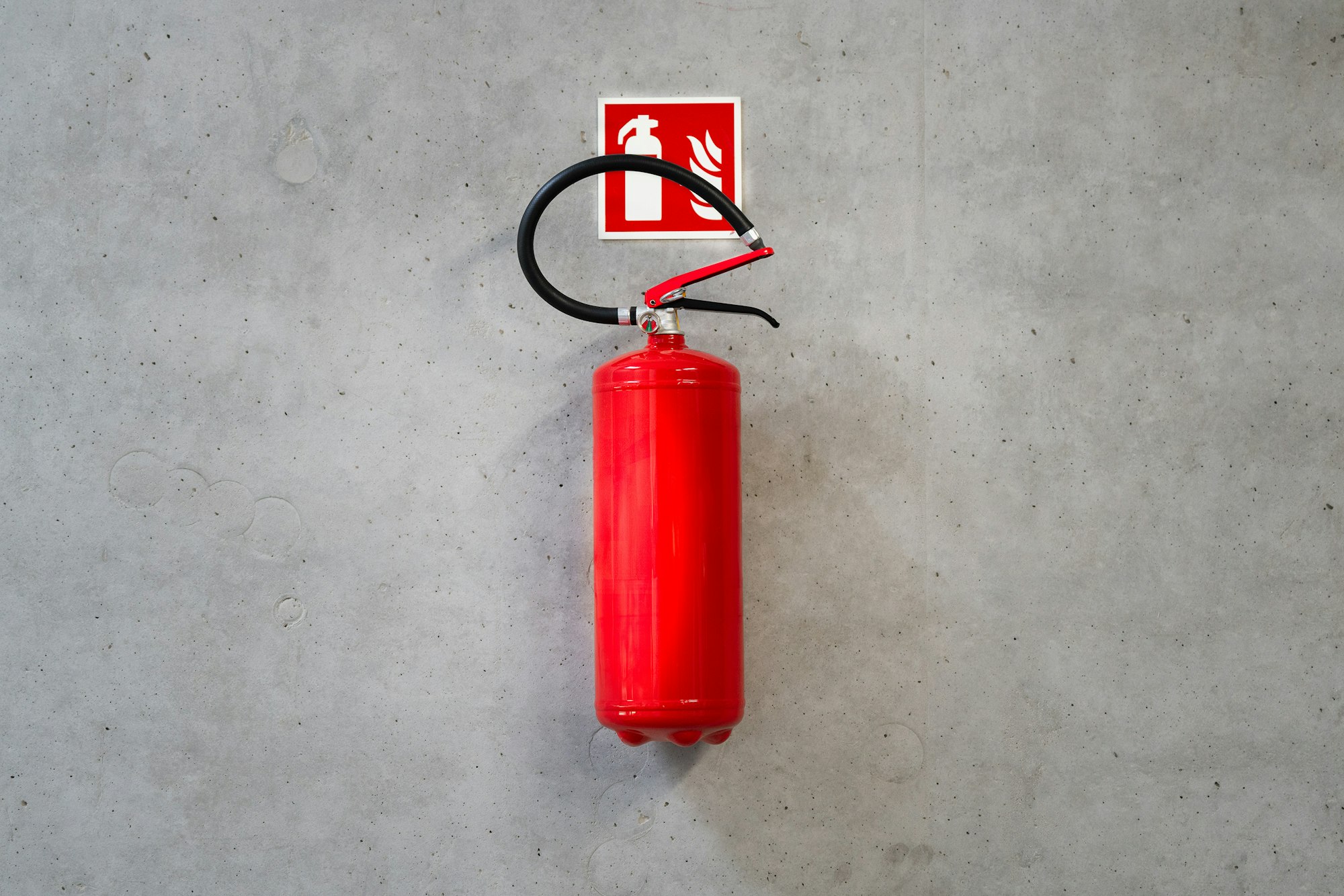 Fire extinguisher on a concrete wall